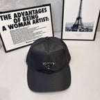 Prada baseball cap in dark fabric with front triangular logo patch and curved brim