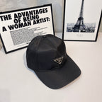 Prada baseball cap, angled front, dark fabric with triangular Prada logo patch