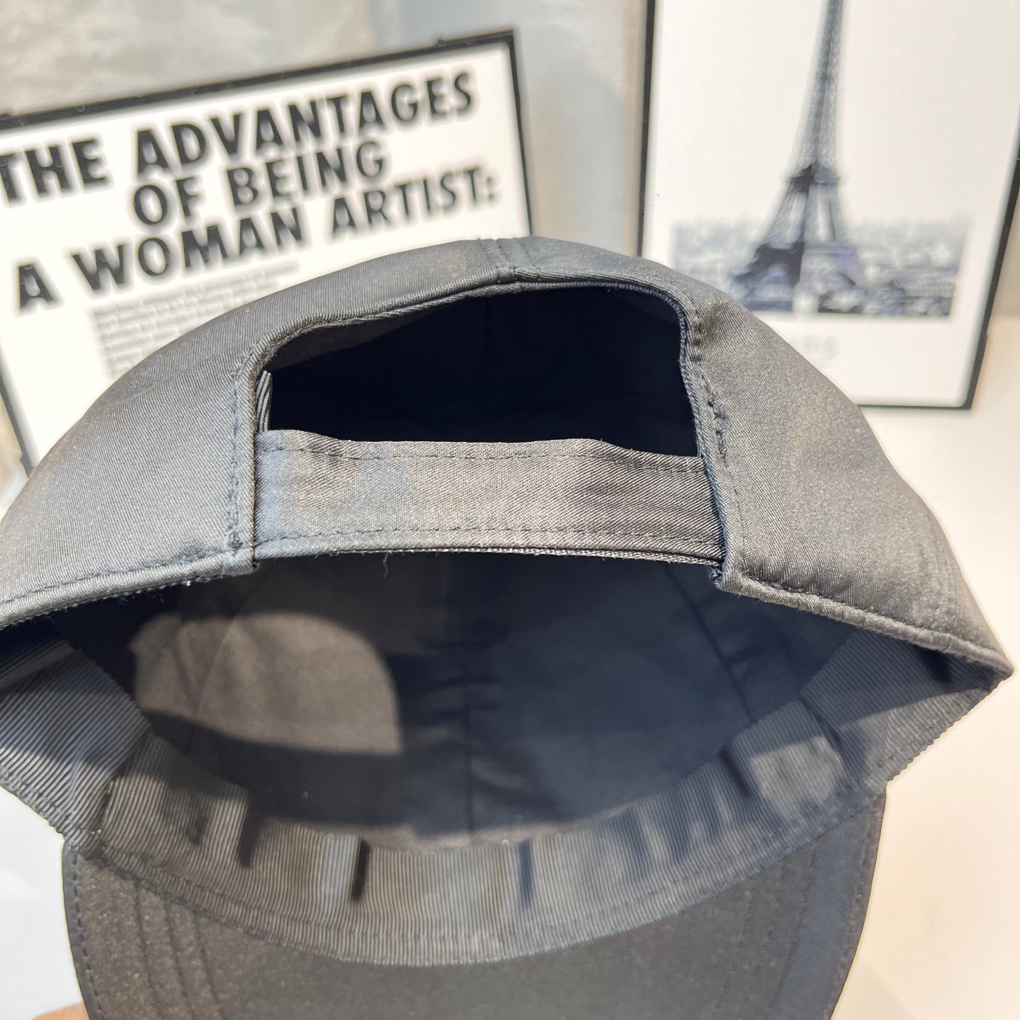 Prada baseball cap interior view with open lining and curved brim stitching