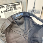 Prada cap interior with fabric strap and small branded label near opening.