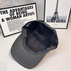 Prada cap interior view with stitched lining and curved brim edge.