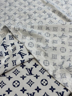 Light monogram T-shirt fabric close-up with navy and gray allover print