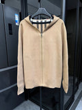 Beige zip-front sweatshirt with raised collar and black-and-white striped inner hood