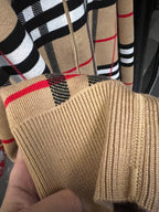 Beige ribbed cuff with plaid lining and red stripe accents at sleeve