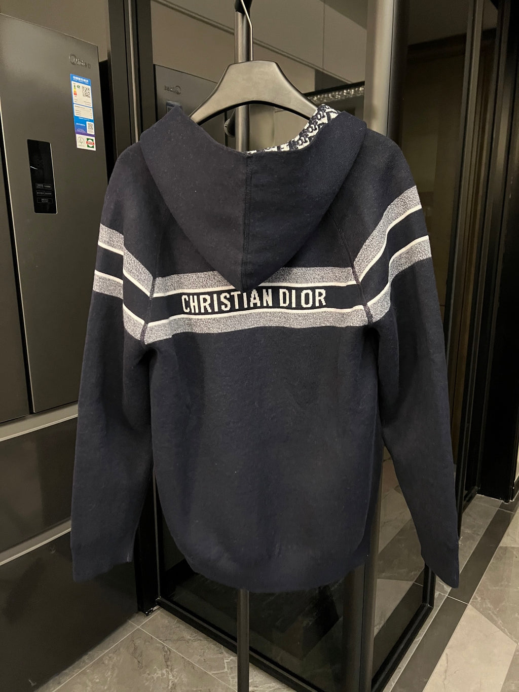 Dior hooded zip jacket with large "CHRISTIAN DIOR" logo stripe across chest