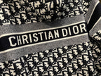 Dior hooded zip jacket close-up of "CHRISTIAN DIOR" logo stripe and knit texture