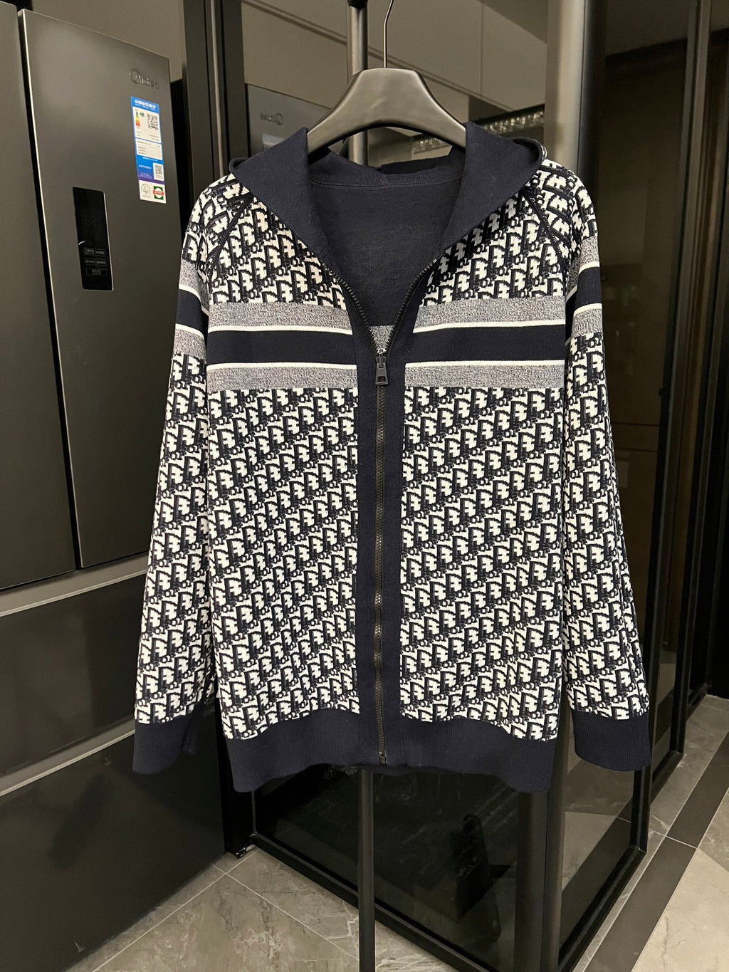 Dior hooded zip jacket with black and white logo print and striped cuffs