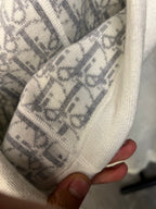 Off-white hoodie hood lining with Dior-style monogram pattern and knit trim.