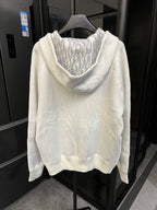 Off-white zip-up hoodie back view with patterned hood lining and long sleeves.