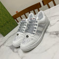 White Gucci unisex sneakers with gray laces and side stripe detail