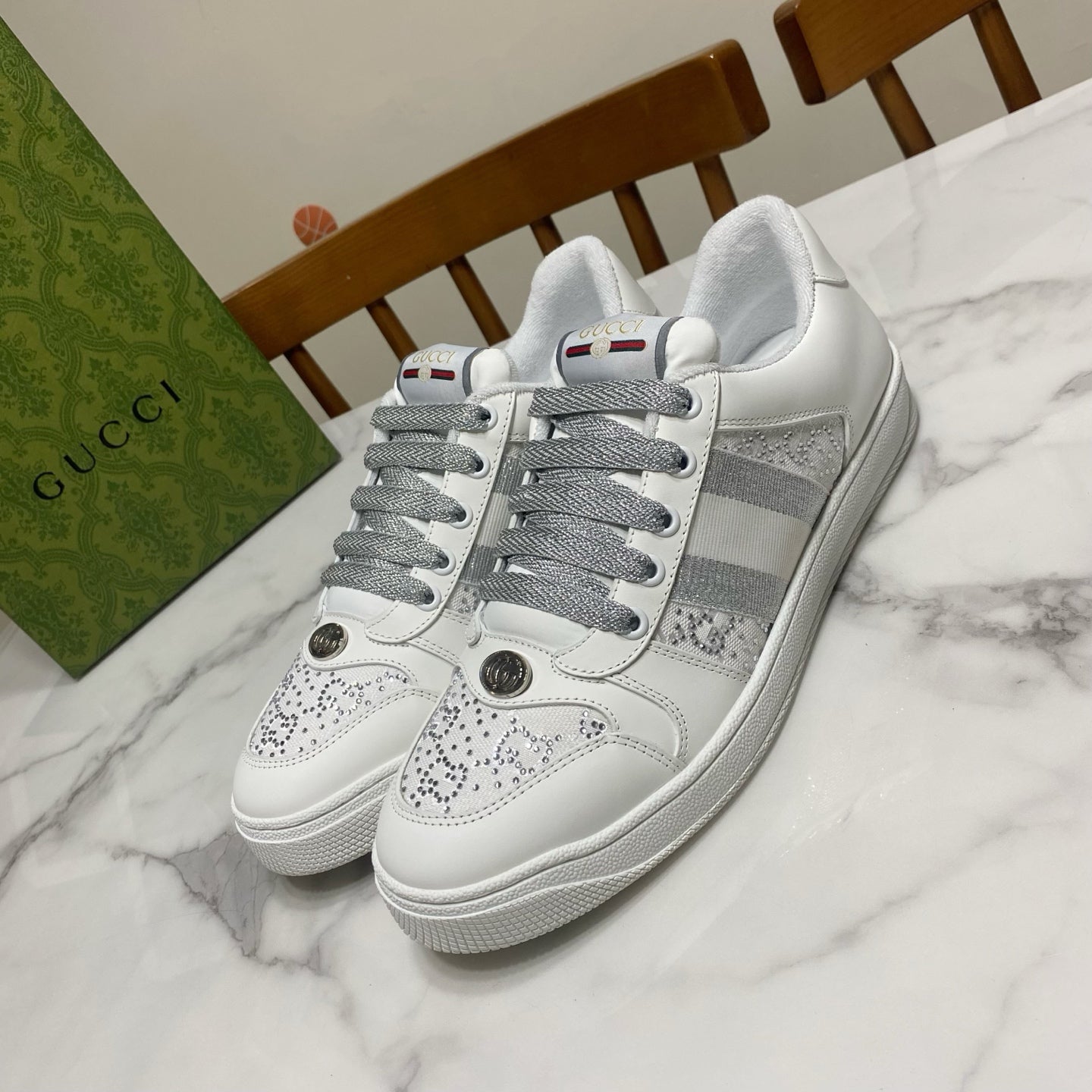White Gucci unisex sneakers with gray laces and side stripe detail