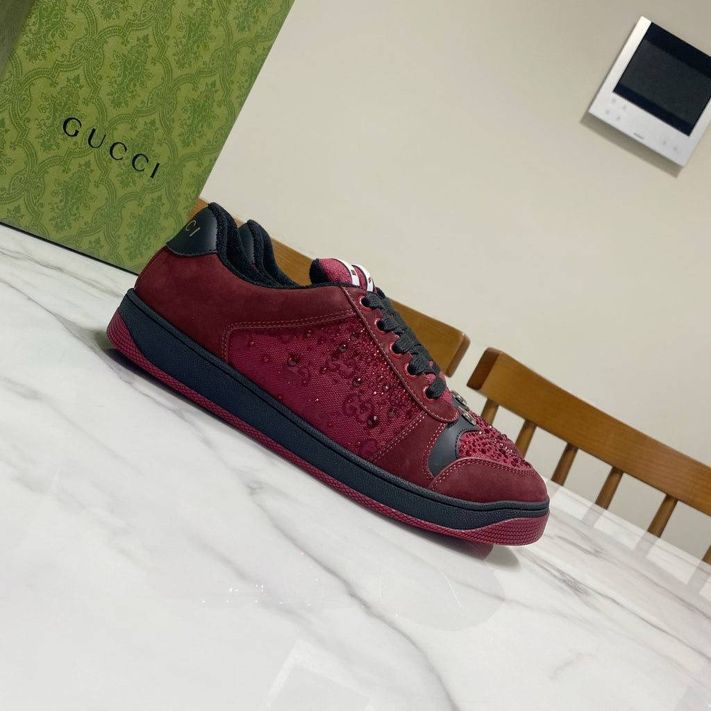 Gucci unisex sneakers side view in burgundy with black trim and lace-up front