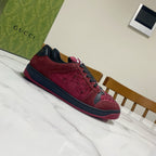 Gucci unisex sneakers side view in burgundy with black trim and lace-up front