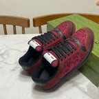 Gucci unisex sneakers pair view with burgundy uppers, black laces, and bold heel accents