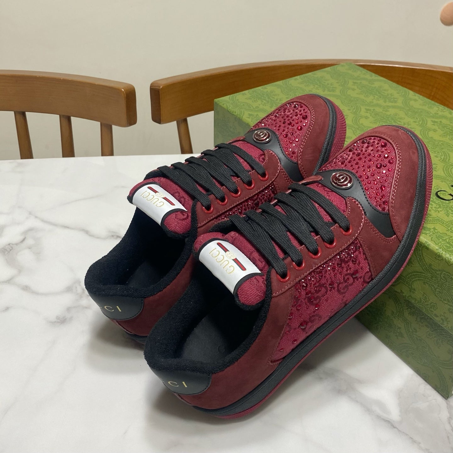 Gucci unisex sneakers pair view with burgundy uppers, black laces, and bold heel accents