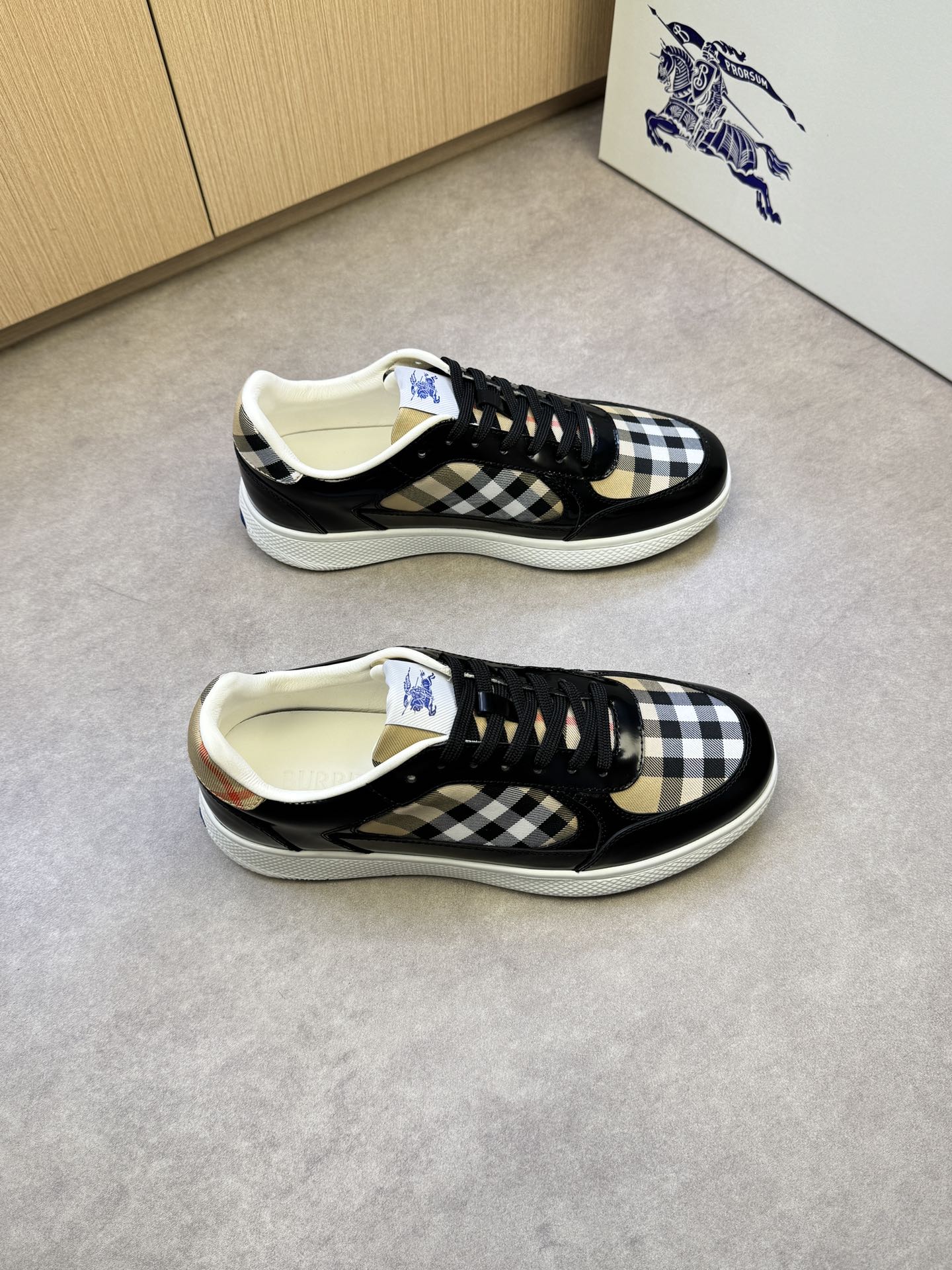 Black and white checkered low-top sneakers with black laces and white rubber sole