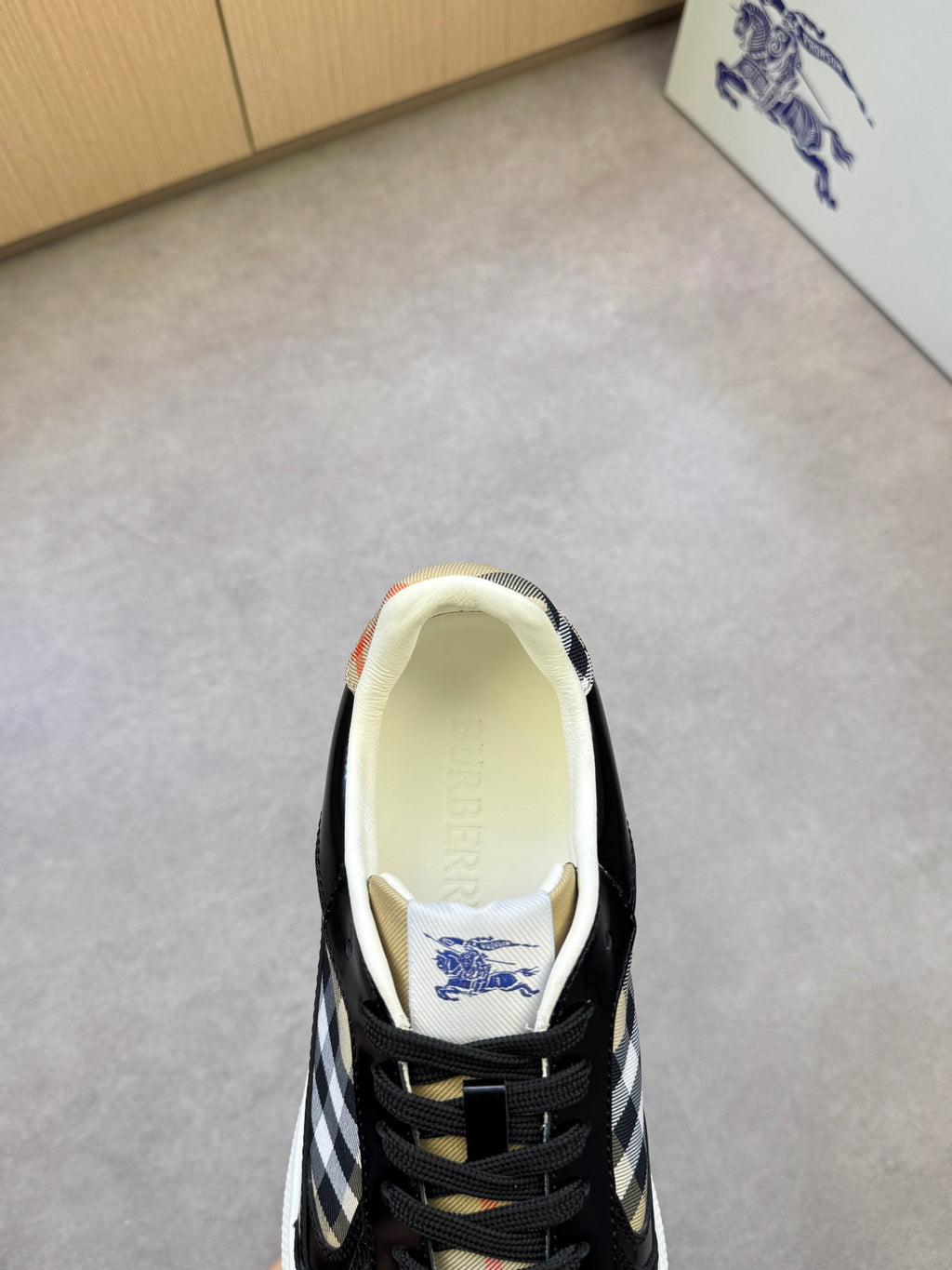Black and white checkered sneaker interior view with cream lining and lace-up front