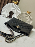 Black quilted Chanel handbag with chain strap and gold-tone hardware, open side view