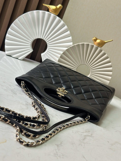Black quilted Chanel handbag with chain strap and gold-tone hardware, open side view
