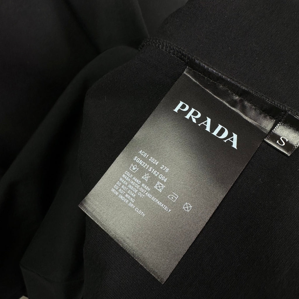 Prada black T-shirt care tag and size label near collar
