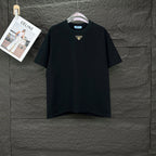 Prada black short-sleeve T-shirt with small gold triangle logo at chest