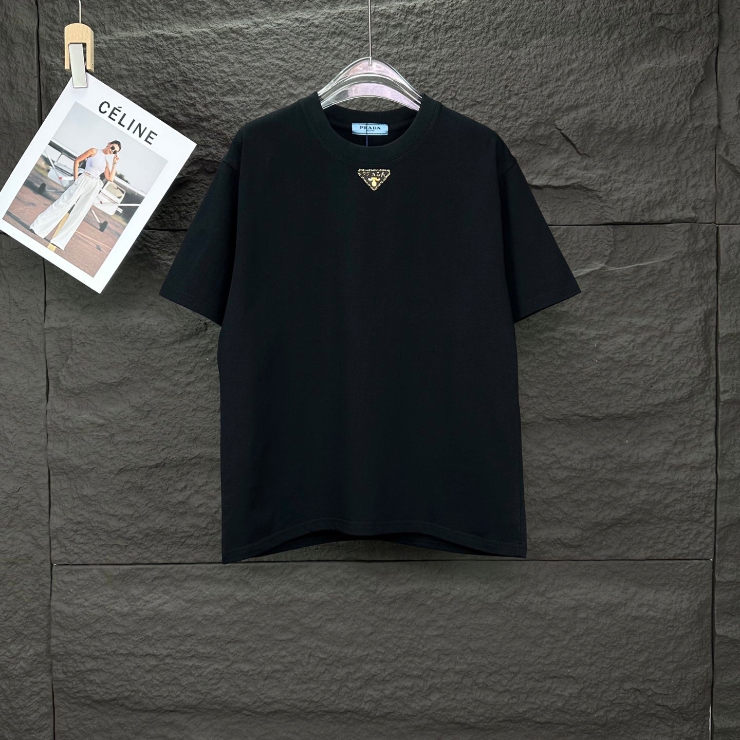 Prada black short-sleeve T-shirt with small gold triangle logo at chest