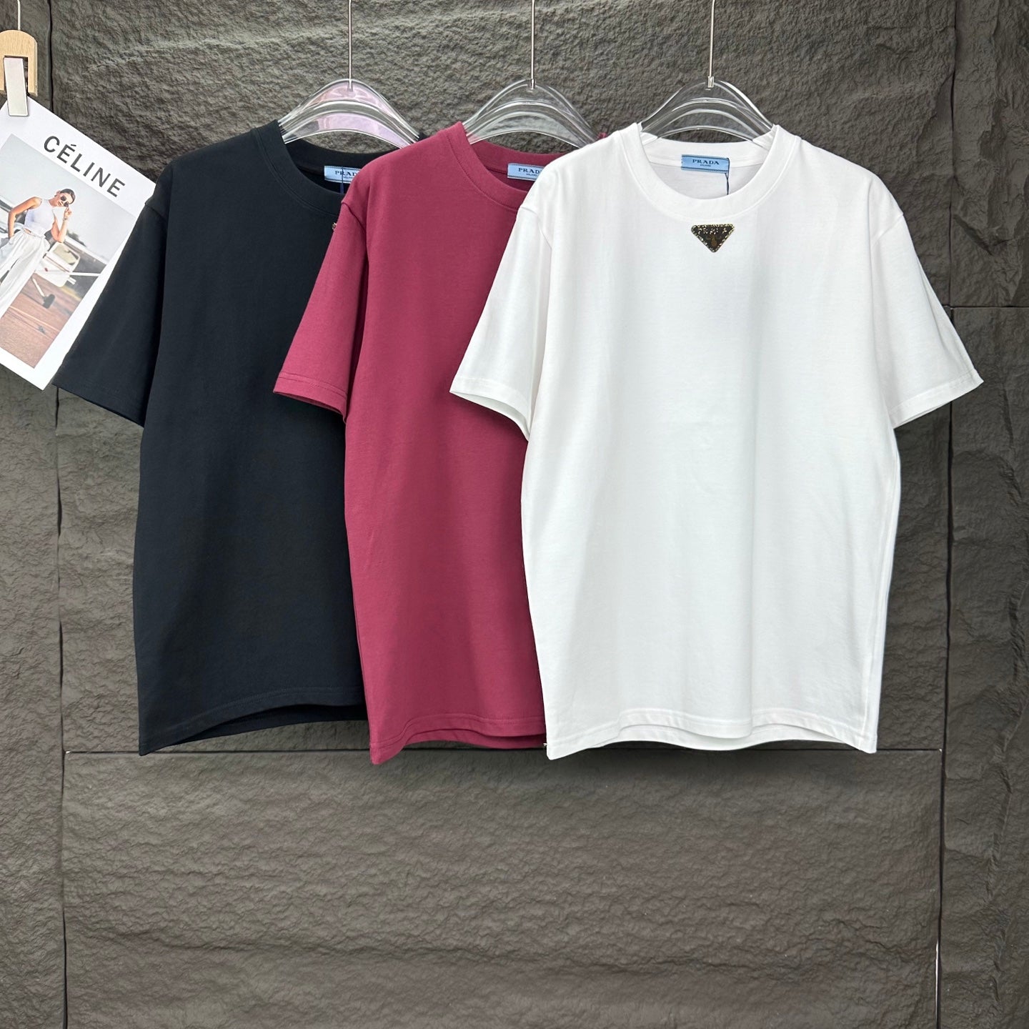 Prada short-sleeve T-shirts on hangers: white, black, and maroon