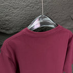 Maroon short-sleeve T-shirt back view on a hanger