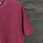 Maroon short-sleeve T-shirt sleeve and shoulder seam detail