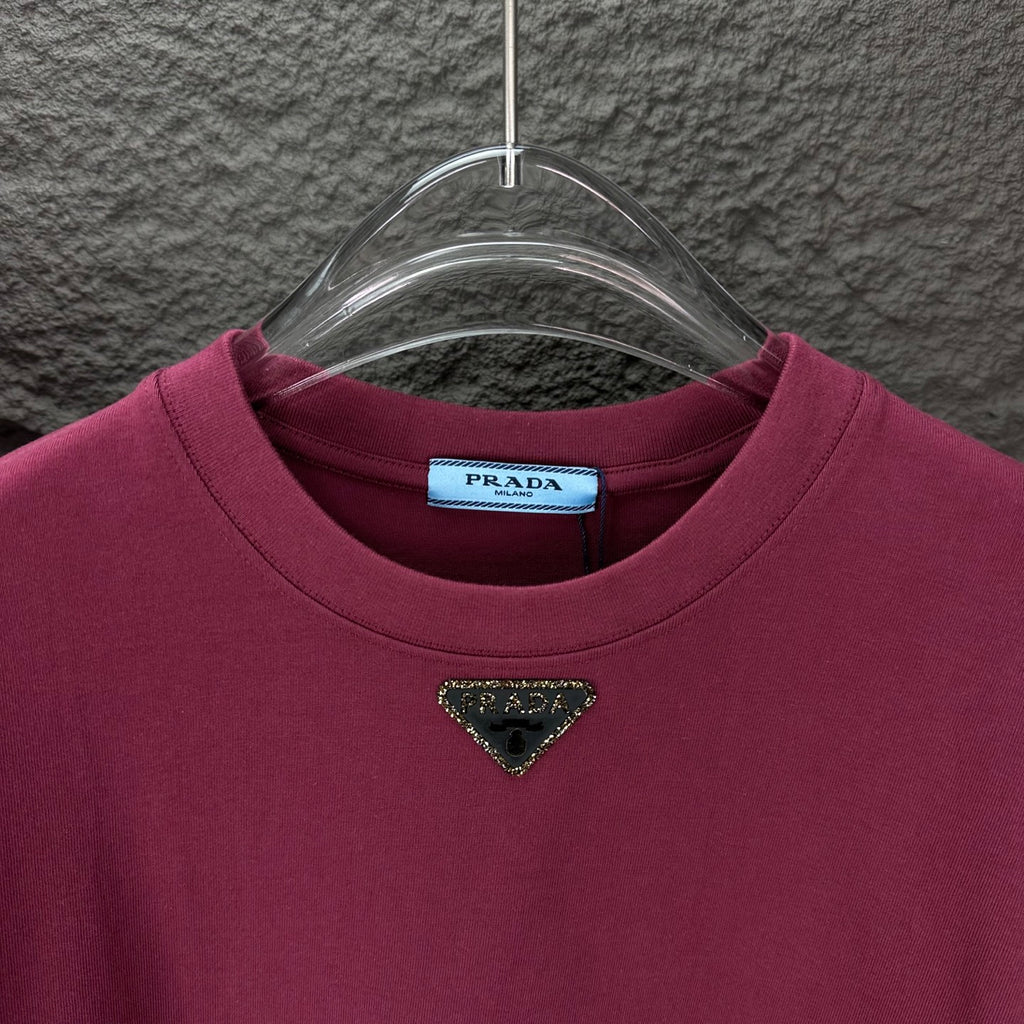 Maroon short-sleeve T-shirt with triangular logo near the neckline