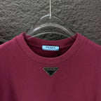 Maroon short-sleeve T-shirt with triangular logo near the neckline