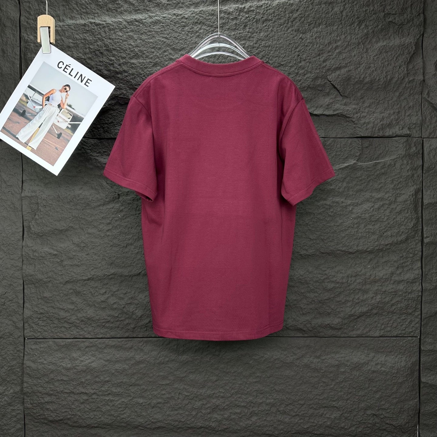 Prada short-sleeve T-shirt in dark berry, shown from the back on a hanger.