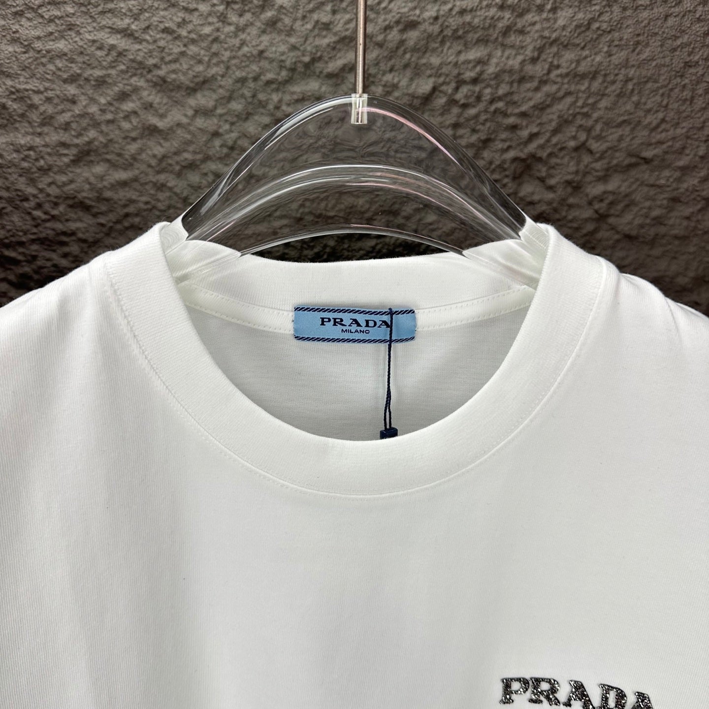 White short-sleeve T-shirt neckline with blue PRADA size label