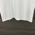 White short-sleeve T-shirt with curved hem on hanger
