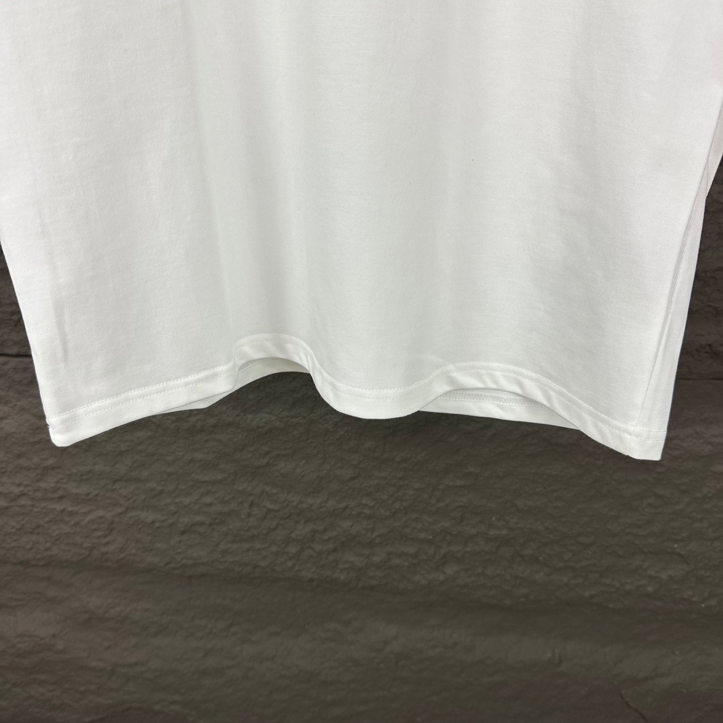 White short-sleeve T-shirt with curved hem on hanger