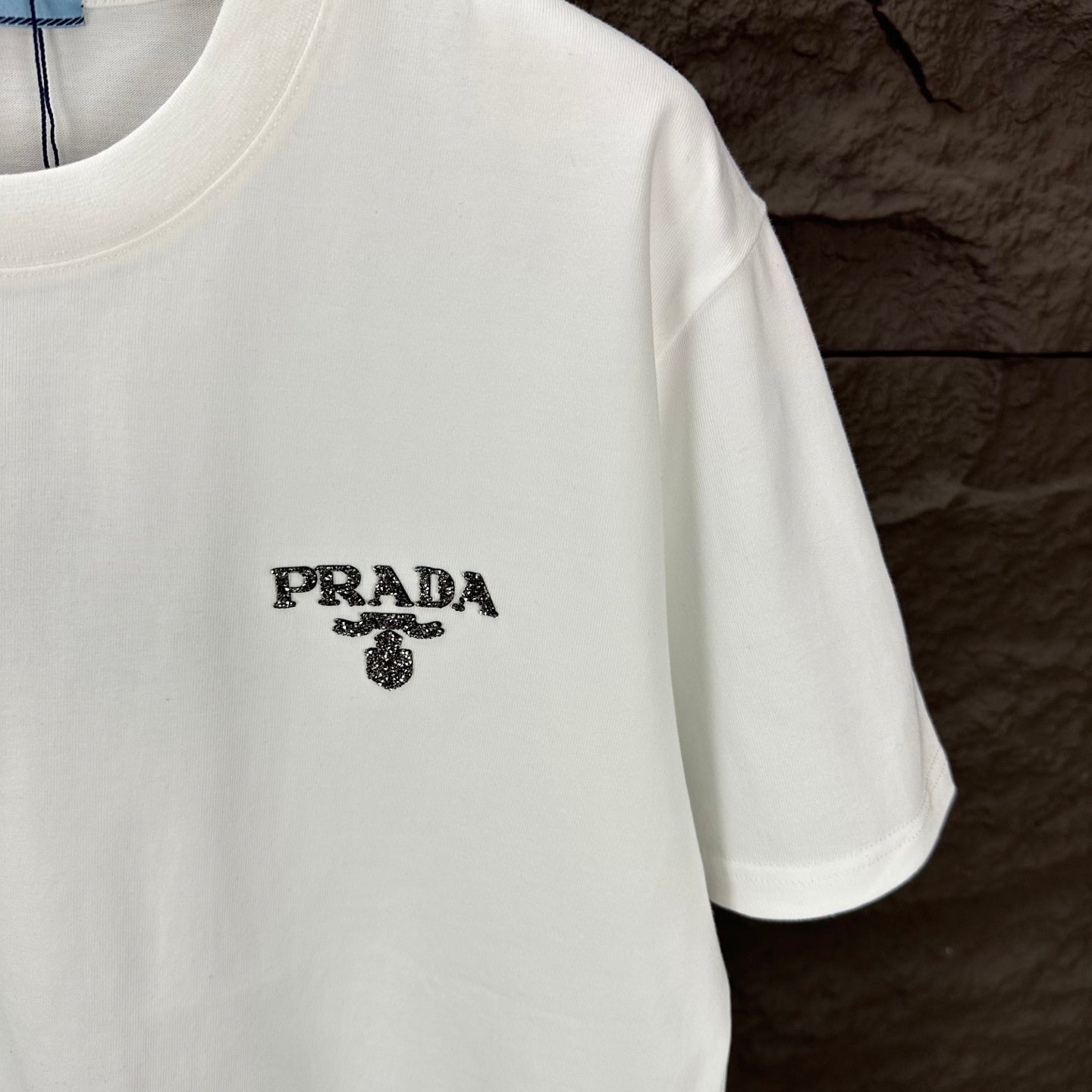 White short-sleeve T-shirt with PRADA logo graphic on chest