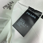 PRADA clothing label tag on white T-shirt