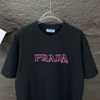 Prada short-sleeve T-shirt, black with centered pink PRADA MILANO chest print