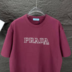 Burgundy crewneck Prada T-shirt with PRADA MIL ANO logo, front view