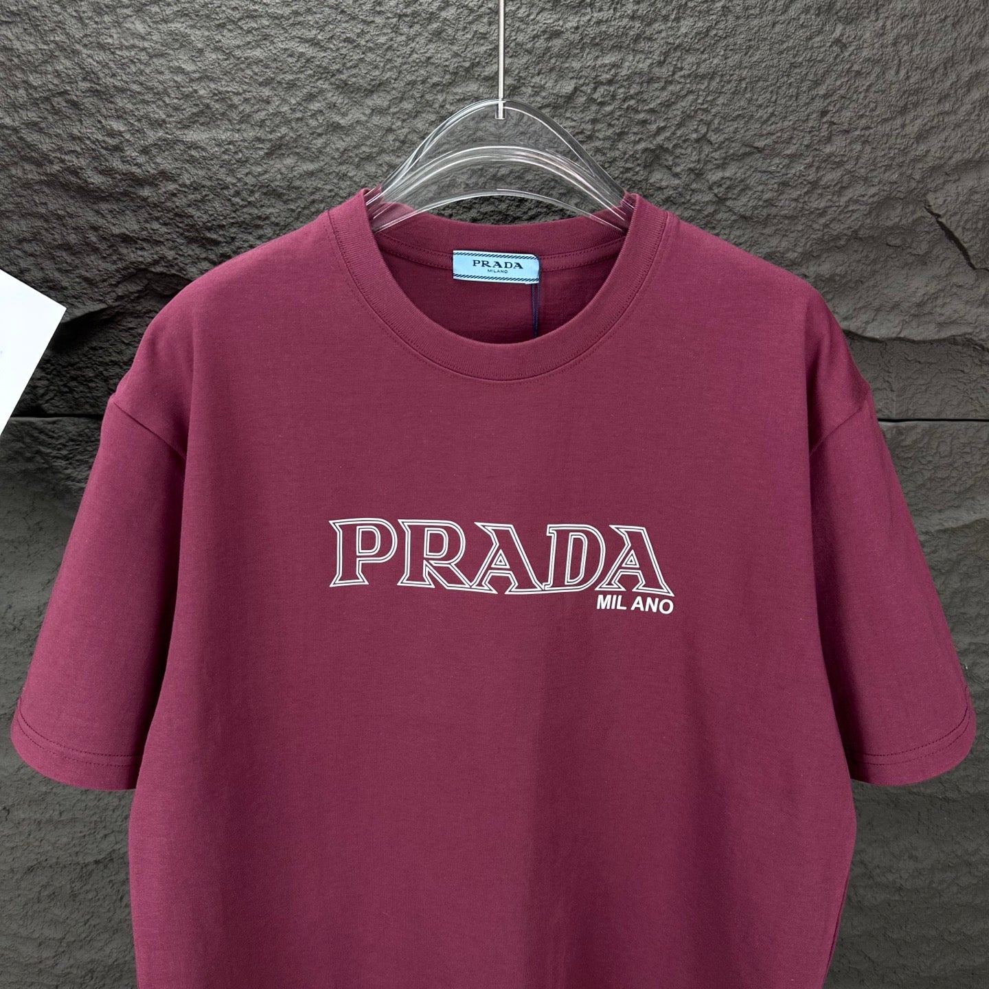 Burgundy crewneck Prada T-shirt with PRADA MIL ANO logo, front view