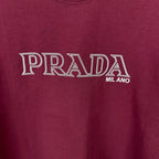 Burgundy T-shirt with PRADA MIL ANO logo print at center