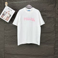 Short-sleeve T-shirt in white with pink PRADA MIL ANO logo on the front.