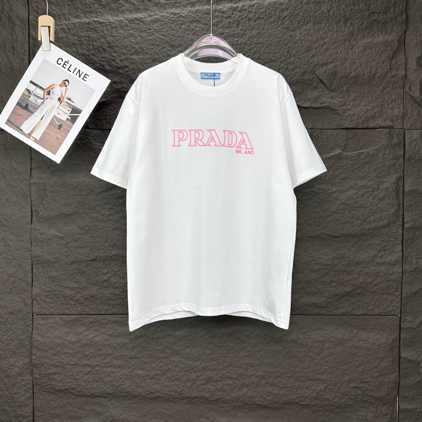 Short-sleeve T-shirt in white with pink PRADA MIL ANO logo on the front.