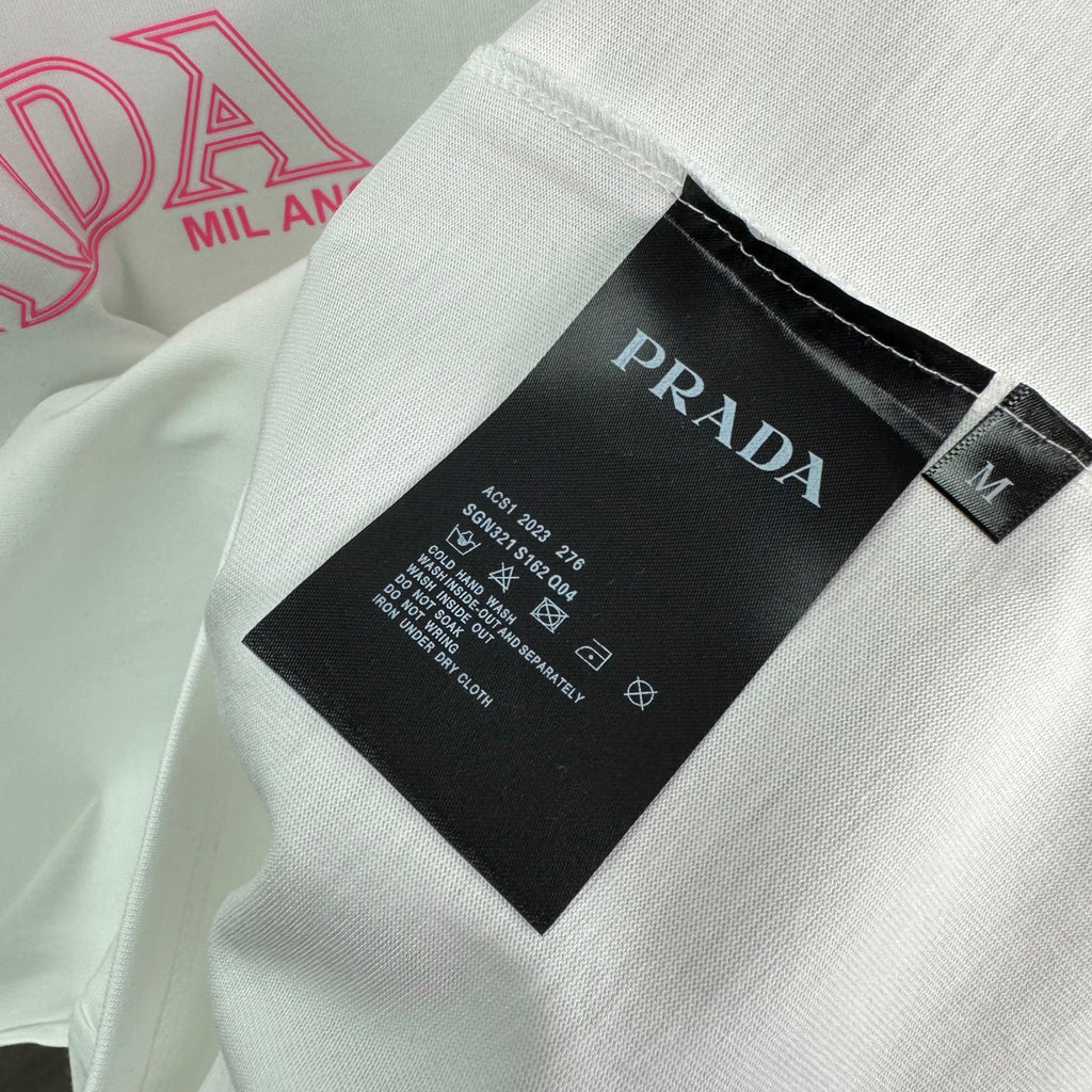 T-shirt interior neck label: Prada brand tag on white fabric.
