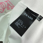 T-shirt interior neck label: Prada brand tag on white fabric.