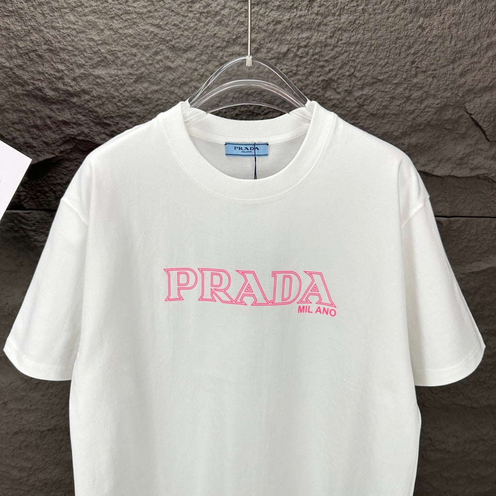 White short-sleeve T-shirt with pink PRADA MIL ANO logo on the chest.