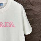 White short-sleeve T-shirt with partial pink PRADA MIL ANO logo print.