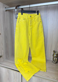 Bright yellow pants with front button closure and cross patches, hanging on a rack.