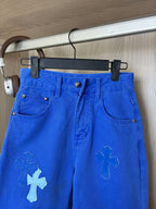 Blue denim pants on hanger with front button and slanted pockets