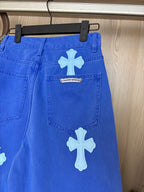 Blue denim pants with white cross patch on thigh and small center label